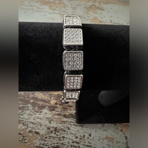 Metal and black nylon cord adjustable costume bracelet. This piece up or down!!